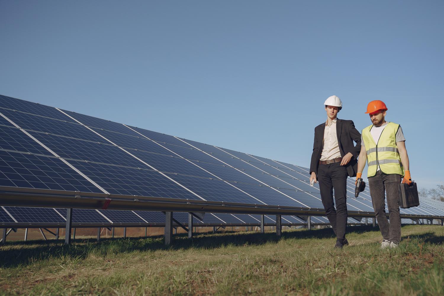 Reunión de Asset Management entre un gestor y un técnico eléctrico analizando la rentabilidad y el estado de una planta solar. Reunión de Asset Management entre un gestor y un técnico eléctrico analizando la rentabilidad y el estado de una planta solar.