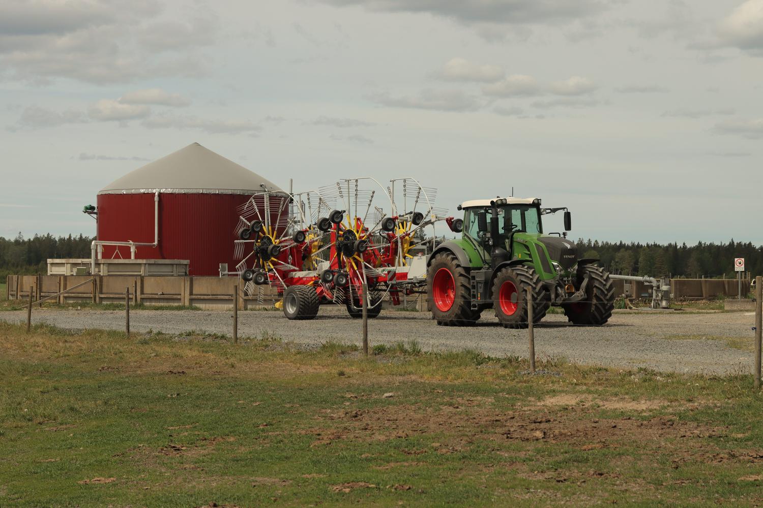 Tractor agrícola junto a un digestor de biogás, representando la conexión entre la economía rural y la energía renovable. Tractor agrícola junto a un digestor de biogás, representando la conexión entre la economía rural y la energía renovable.